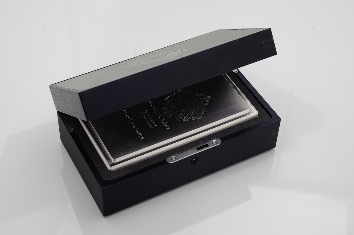 A black box with a silver card holder inside of it