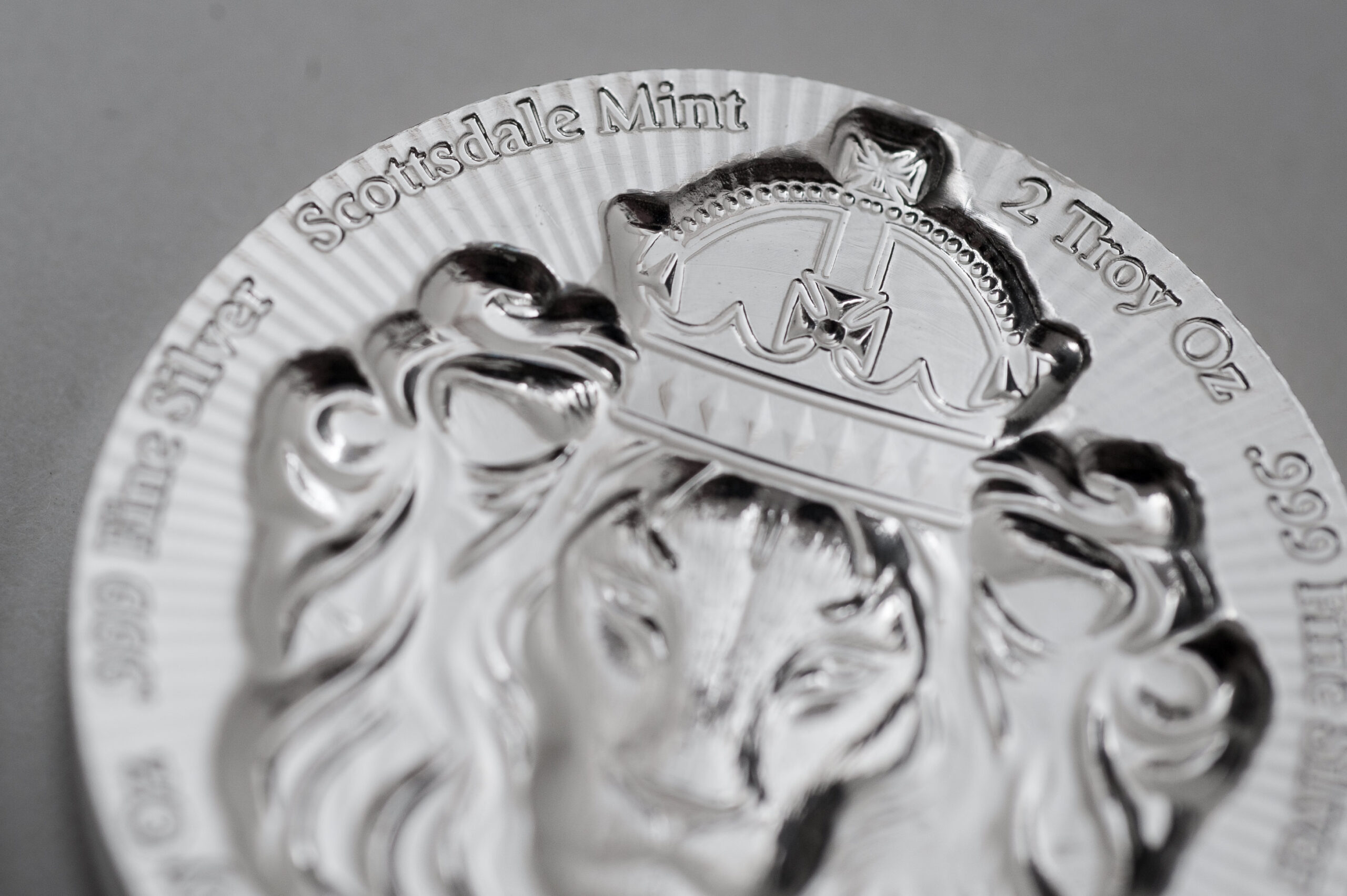 A close up of the crown on a silver plate