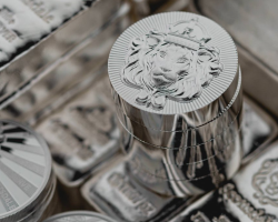 A close up of some silver bars and coins