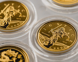 A close up of some gold coins in plastic cases